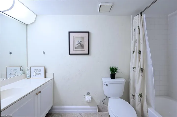 Full bathroom featuring tile patterned floors, vanity, toilet, and shower / bath combo