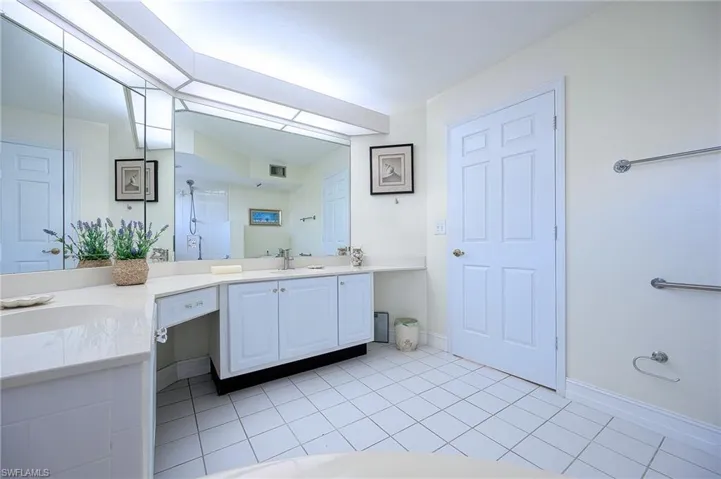 Bathroom with tile patterned floors, vanity, and walk in shower