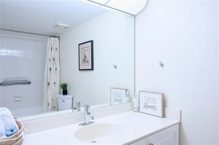 Bathroom with vanity and shower / tub combo