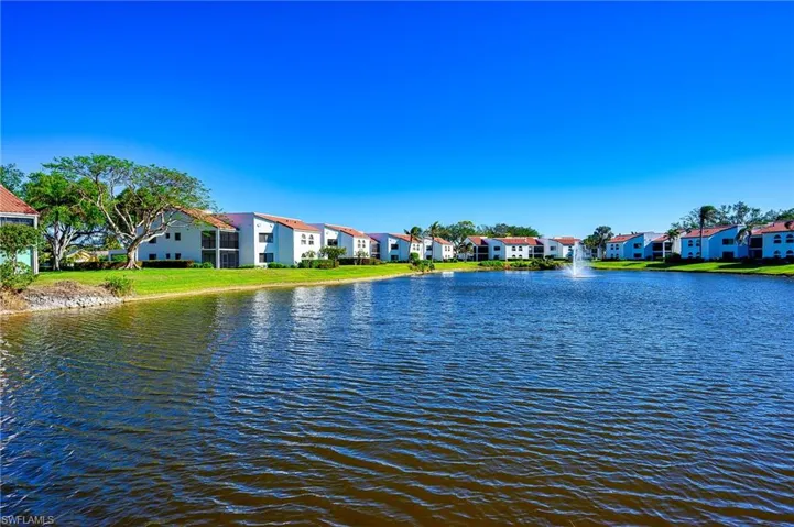Property lanai view of lake with water feature