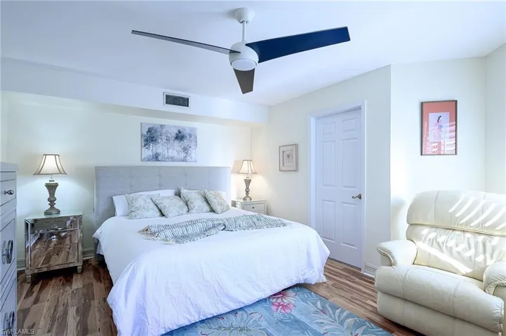 Bedroom featuring dark hardwood / wood-style flooring and ceiling fan