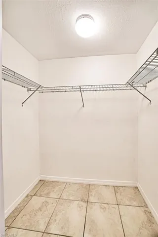 Spacious closet featuring light tile patterned floors