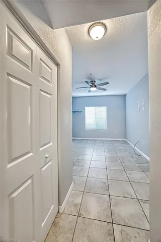 Hall featuring light tile patterned floors