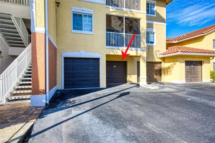 View of front of home featuring a balcony and a garage