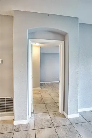 Corridor featuring light tile patterned flooring