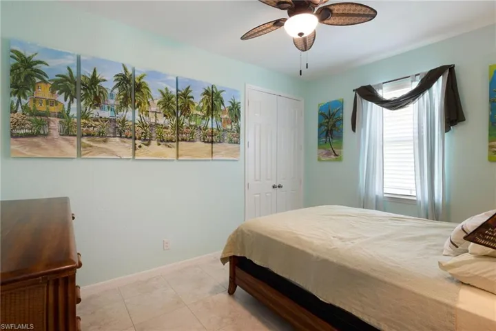 Tiled bedroom featuring a closet and ceiling fan