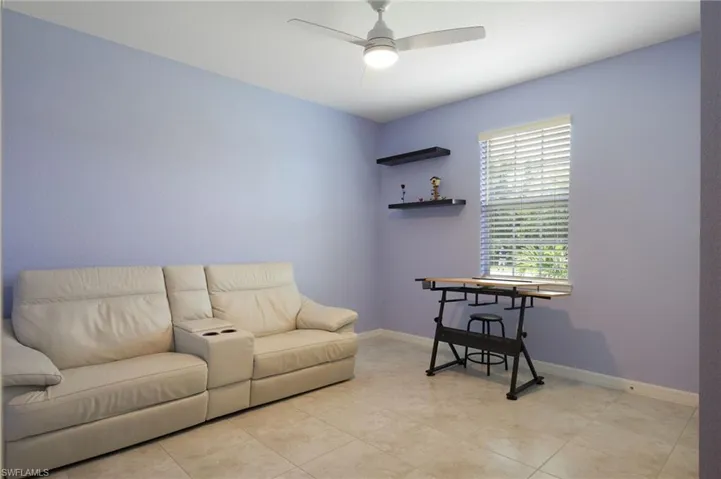 Tiled living room featuring ceiling fan