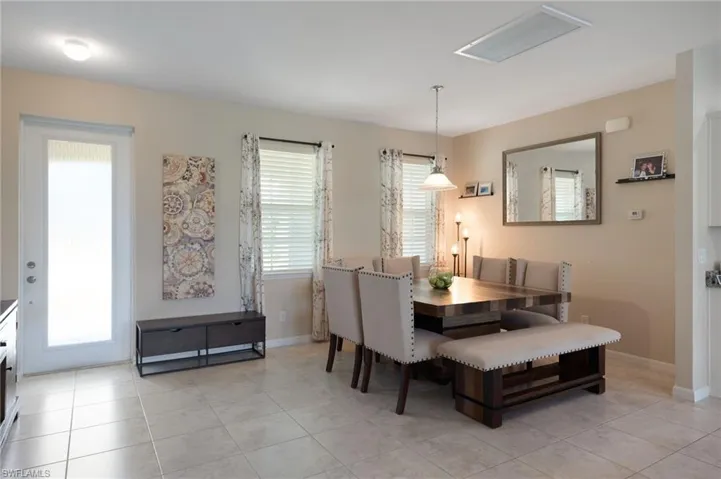 Dining space featuring light tile patterned flooring and plenty of natural light
