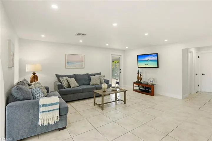 Living room featuring recessed lighting and light tile patterned flooring
