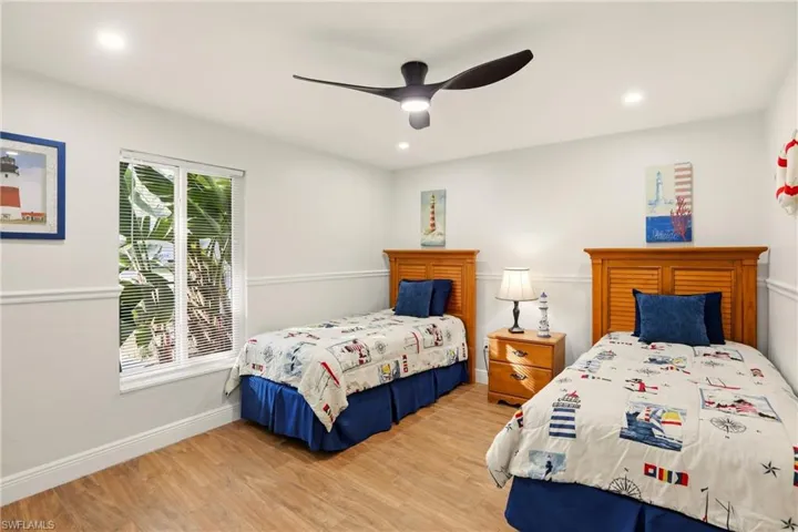 Bedroom featuring light wood-style flooring, a ceiling fan, and recessed lighting