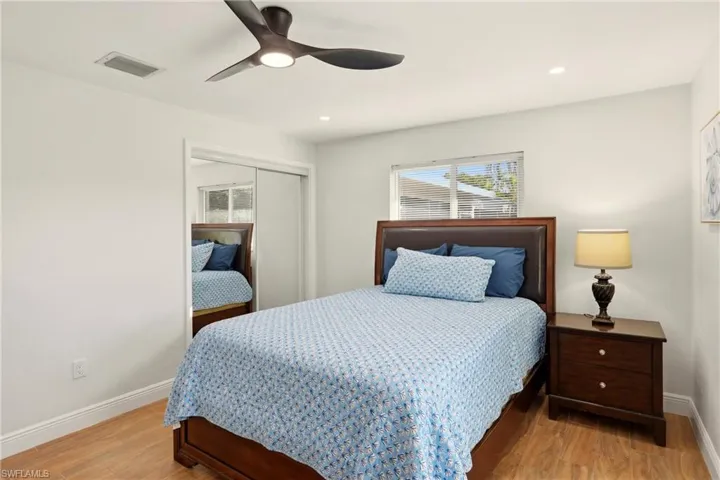 Bedroom featuring a closet, ceiling fan, light wood-style floors, and recessed lighting