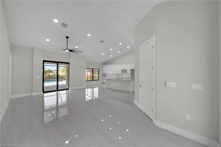 Unfurnished living room featuring recessed lighting, high vaulted ceiling, ceiling fan, and light wood finished floors