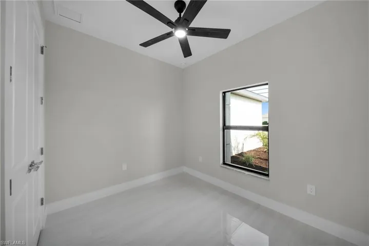 Spare room with baseboards and ceiling fan