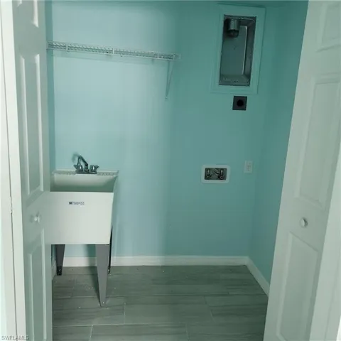 Laundry area featuring electric dryer hookup, baseboards, and hookup for a washing machine