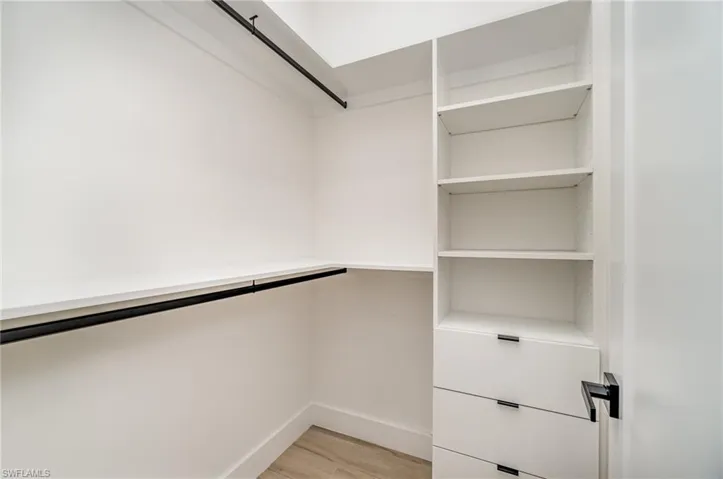 Spacious closet featuring light wood-type flooring
