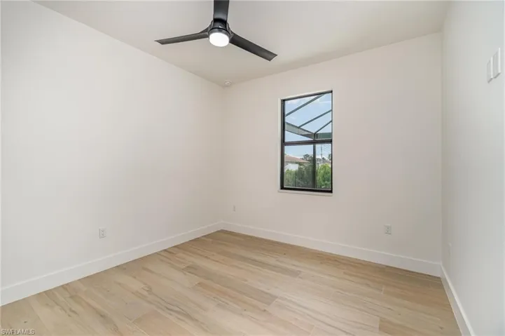 Empty room featuring light wood-type flooring and ceiling fan