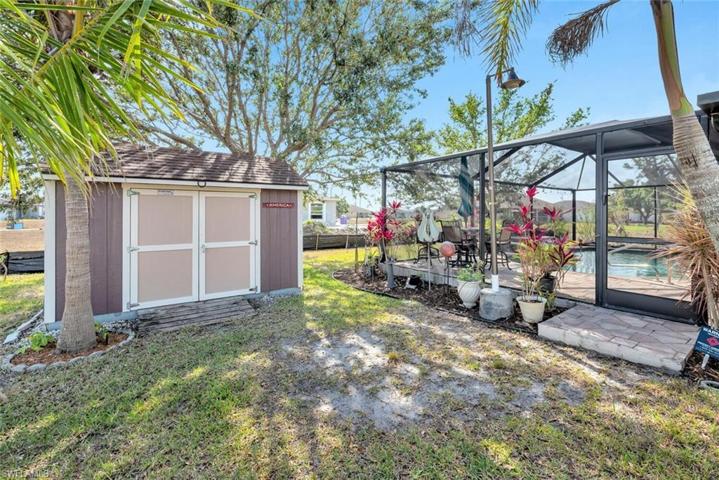 Shed with push lawnmower, drive lawnmower and tools, shovels, etc. for you