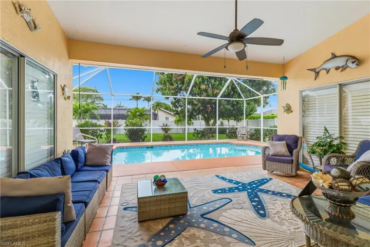 View of swimming pool with outdoor lounge area, a sunroom, a patio, and a lanai