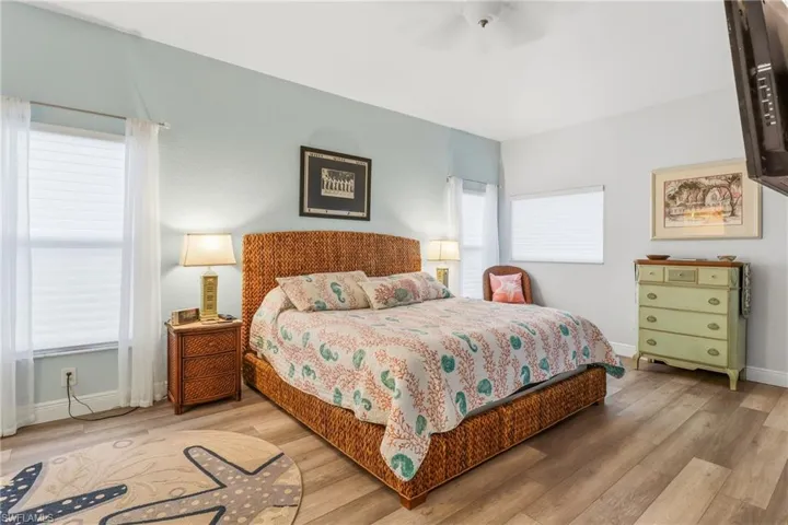 Bedroom with wood finished floors and a ceiling fan