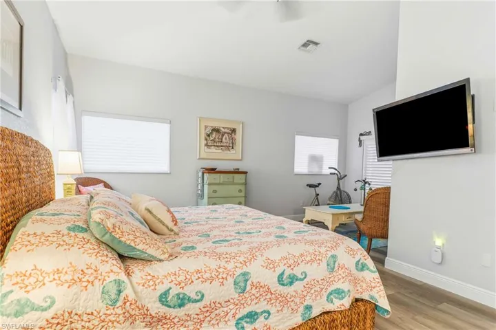 Bedroom with light wood finished floors and a ceiling fan