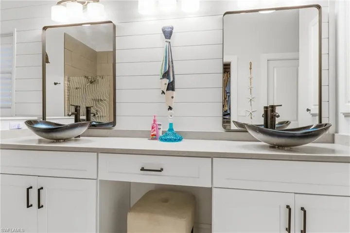 Bathroom featuring double vanity and a shower