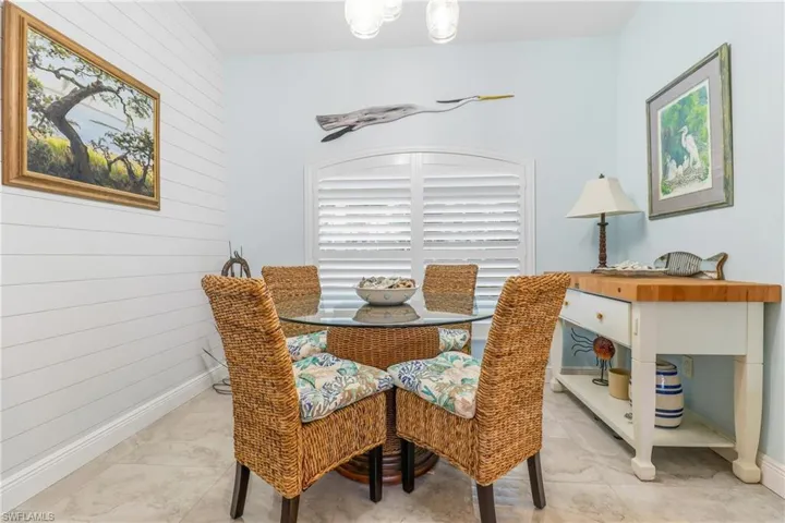 Dining room featuring wood walls and baseboards