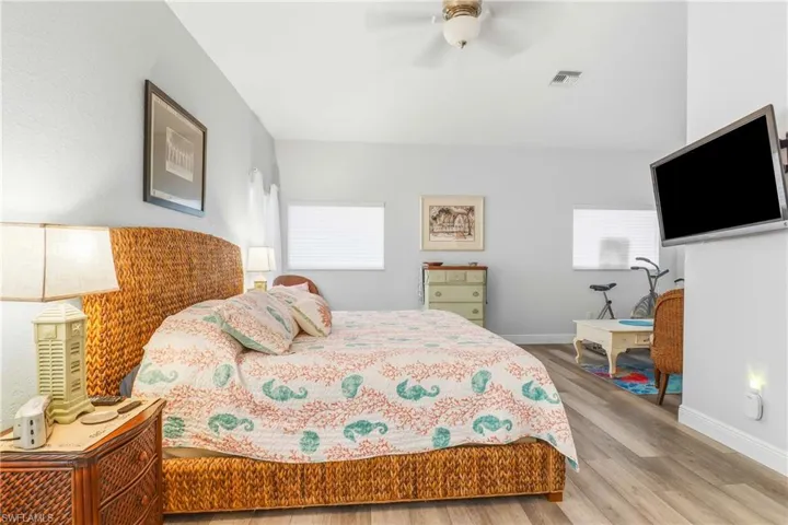 Bedroom with wood finished floors and ceiling fan