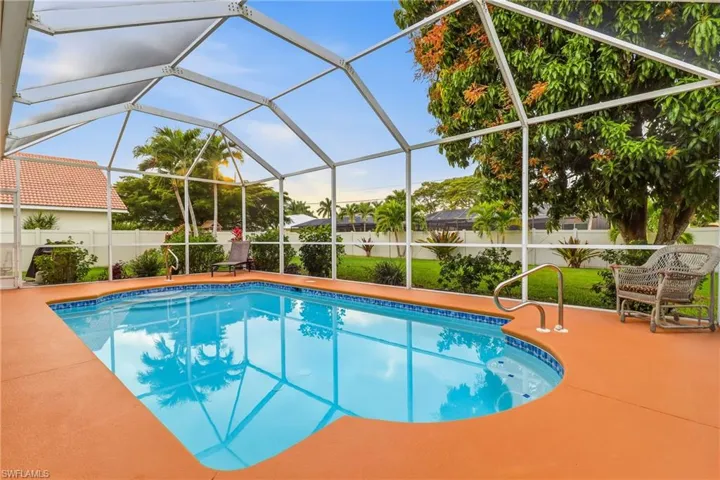 View of swimming pool with a lanai, a sunroom, and a patio