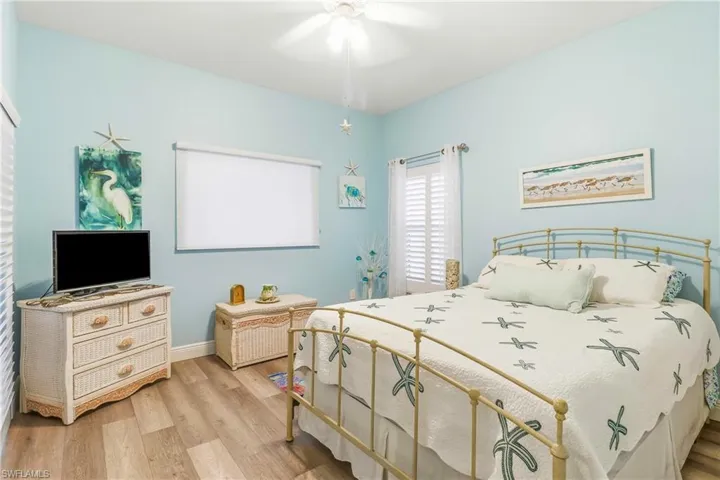 Bedroom with light wood finished floors and ceiling fan
