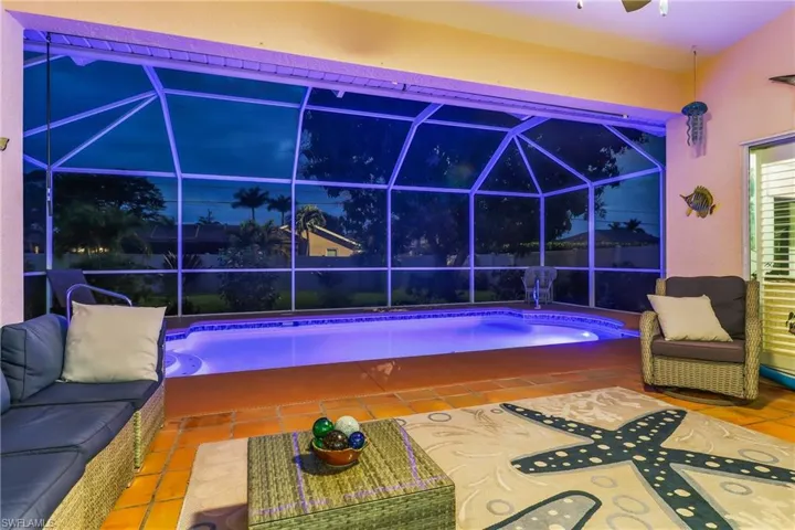 Outdoor pool with a lanai, a sunroom, a patio, and an outdoor living space