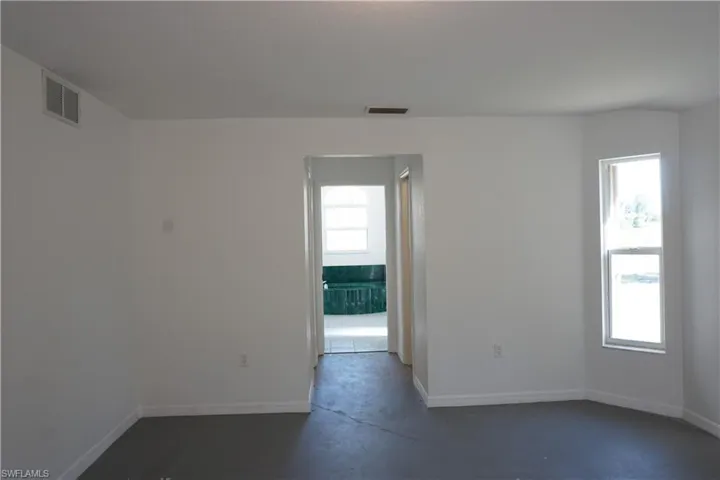 Primary bedroom looking into bathroom - walk in closets in hall