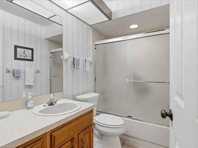 Guest bath with tub and shower.  There is a full sized linen closet just outside of it.