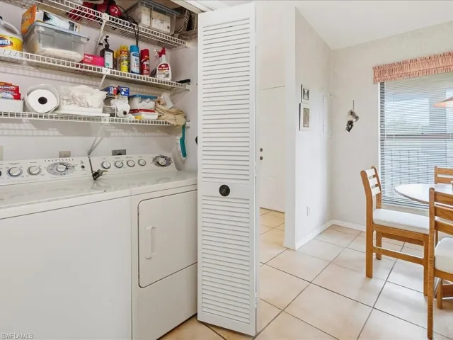 The full sized laundry with storage shelves is in a closet in the kitchen.
