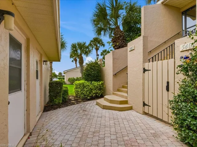 The back door of the garage opens to the paver walkway and is across from your set of stairs.