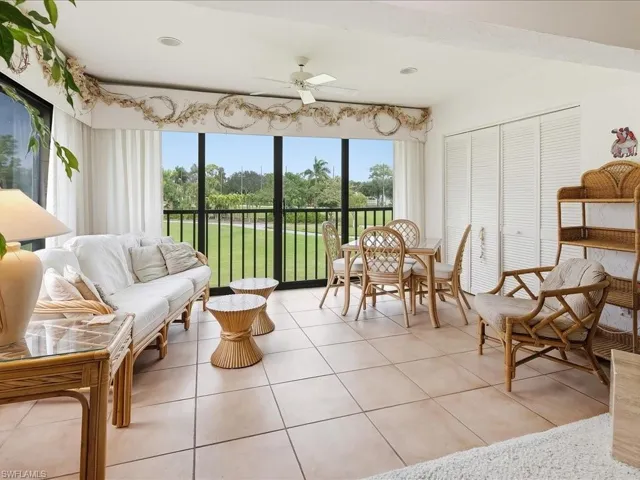 The screened and glassed lanai offers beautiful golf course views of the Red course, hole #1 and the driving range.