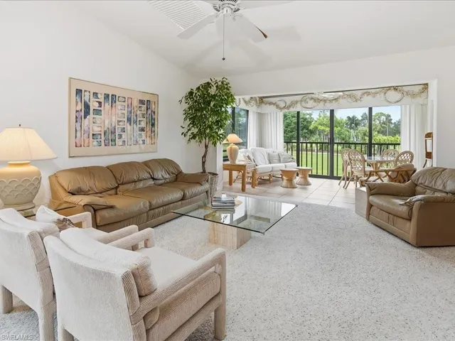 The living room has vaulted ceilings with skylights, ceiling fan and wall to wall carpet.  It is open to the lanai.