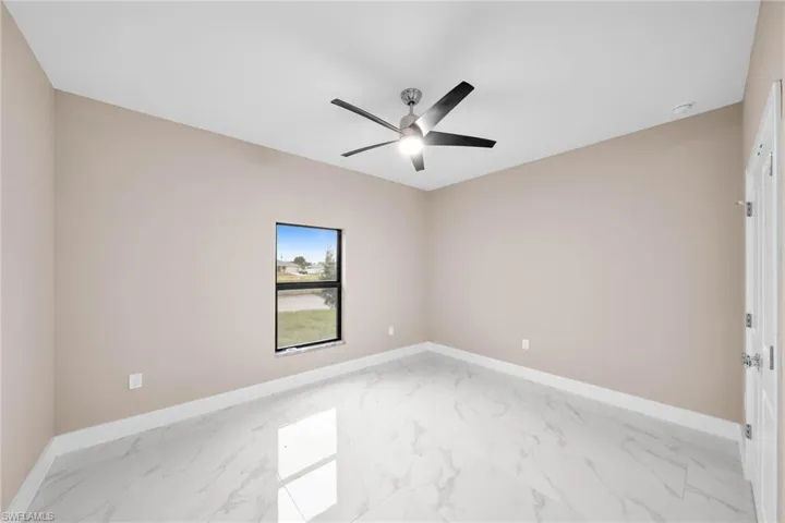 Spare room with ceiling fan