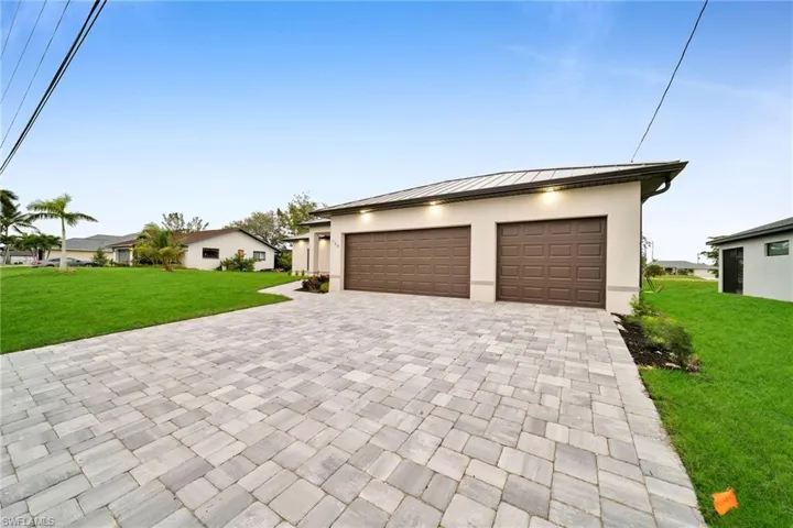 View of front facade with a garage and a front lawn