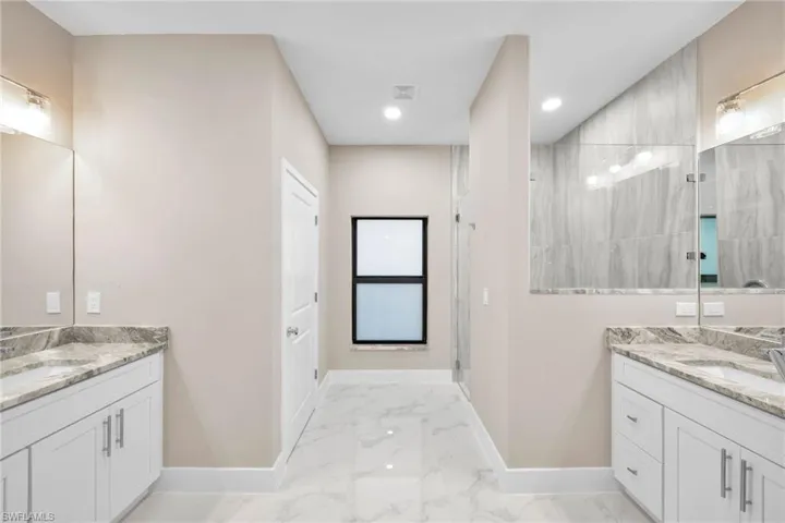 Bathroom featuring vanity and a tile shower