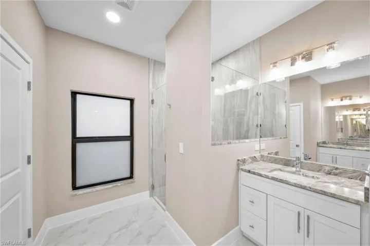 Bathroom with vanity and an enclosed shower