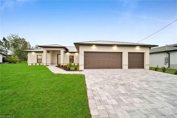 Prairie-style house with a garage and a front yard