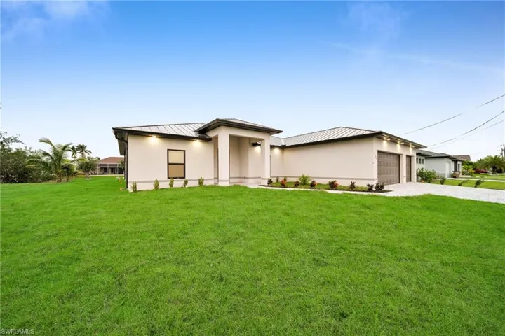 Prairie-style house featuring a garage and a front lawn