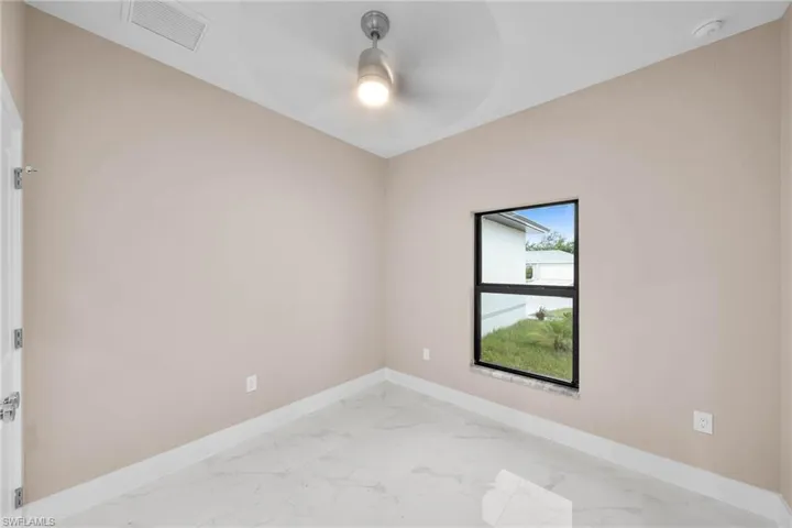 Spare room with ceiling fan