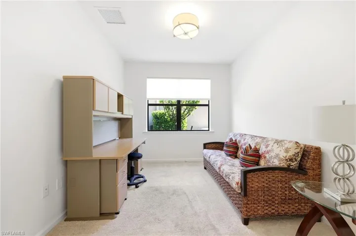 Office area with light carpet and baseboards