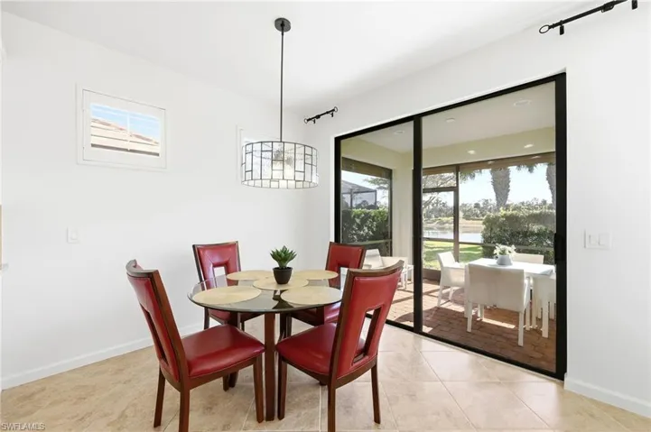 Dining area with healthy amount of natural light and light tile patterned floors