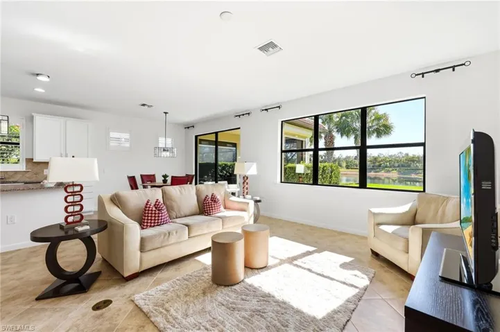 Living room with baseboards and light tile patterned floors
