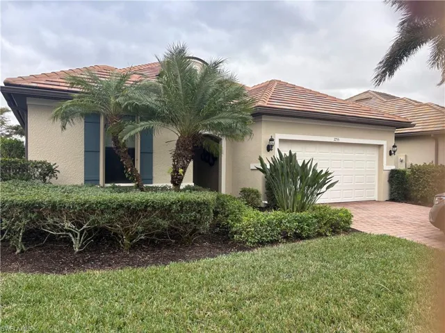 Mediterranean / spanish home featuring a tile roof, stucco siding, decorative driveway, and a garage
