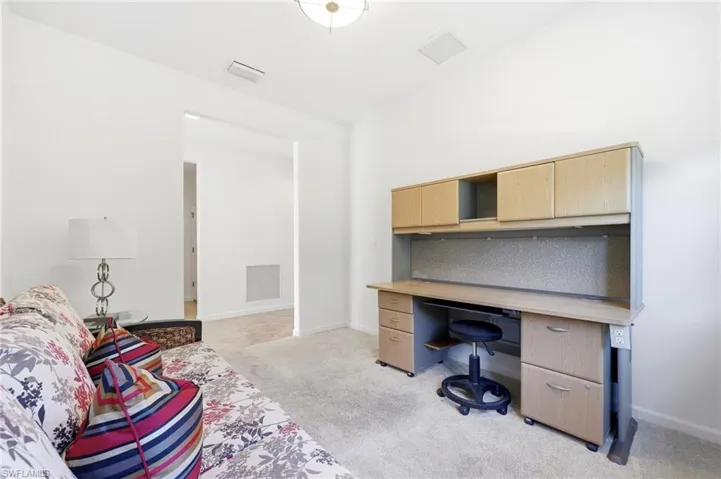 Office area with light carpet and baseboards