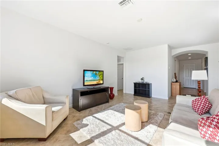 Living area with arched walkways and baseboards