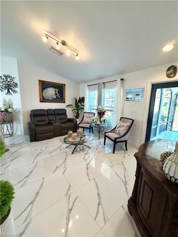 Living room with light marble finish flooring and baseboards